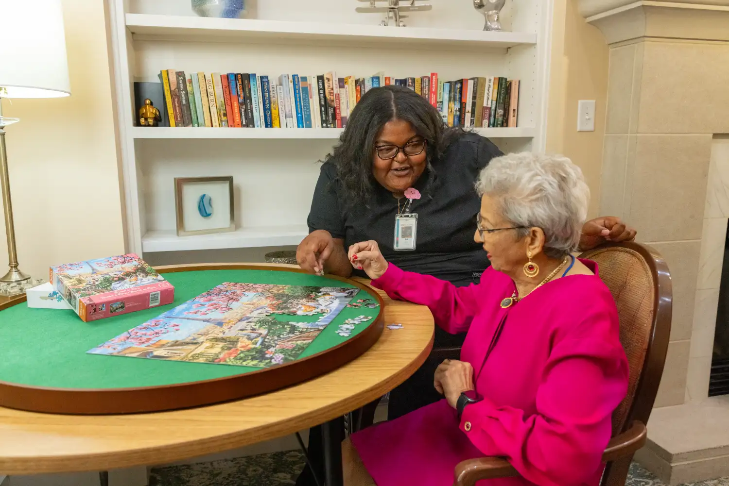 a woman doing a puzzle with a nurse