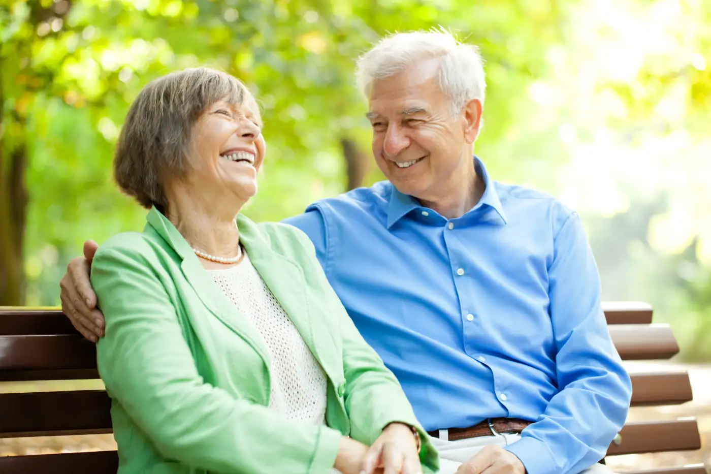 a couple relaxing on a bench outside